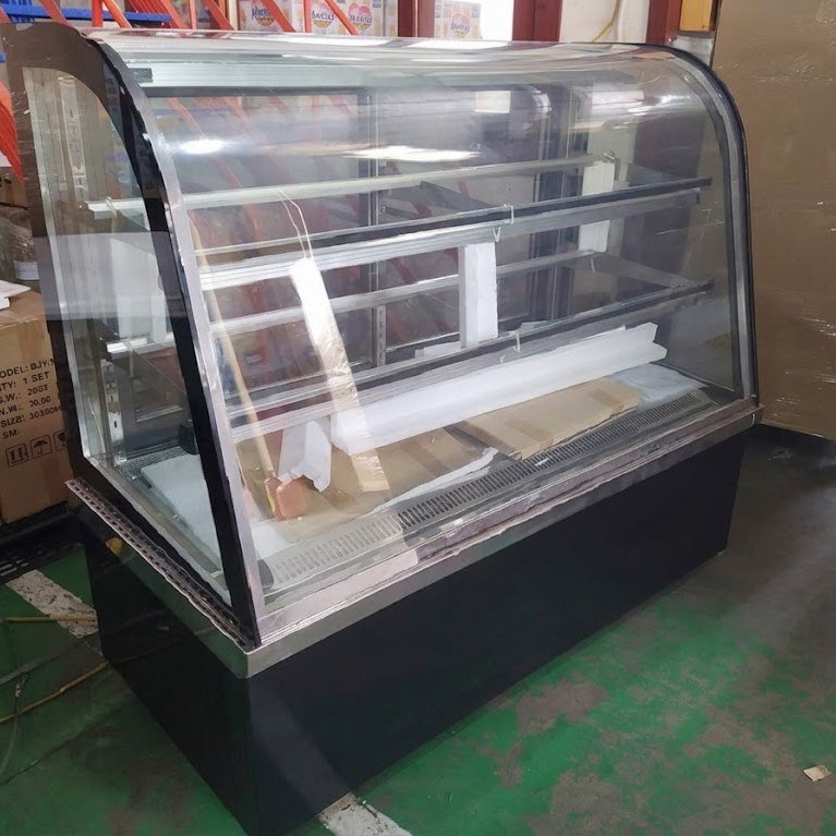 Tủ trưng bày bánh nóng kính cong Berjaya HDW 15SB13-3, chụp thực tế, quầy kính cong đế đen đặt trên sàn xanh